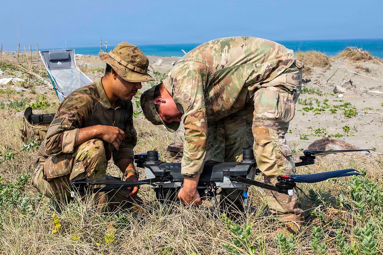Two operators preparing a multirotor unmanned aerial system for launch